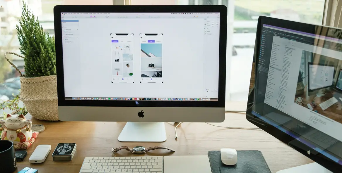 Designer workstation with app screens on a large monitor