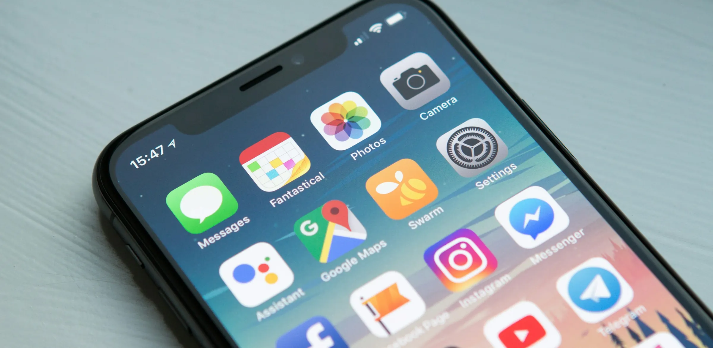 Smartphone with app icons on a table